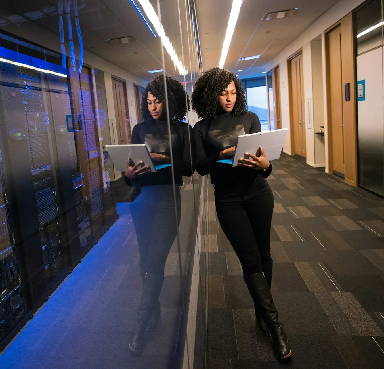 woman in black top using Surface laptop